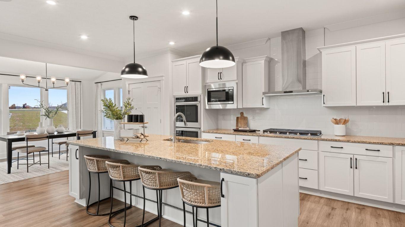 Every home chef’s dream kitchen featuring built-in appliances, oversized kitchen islands, direct vent range hood, &amp; more!