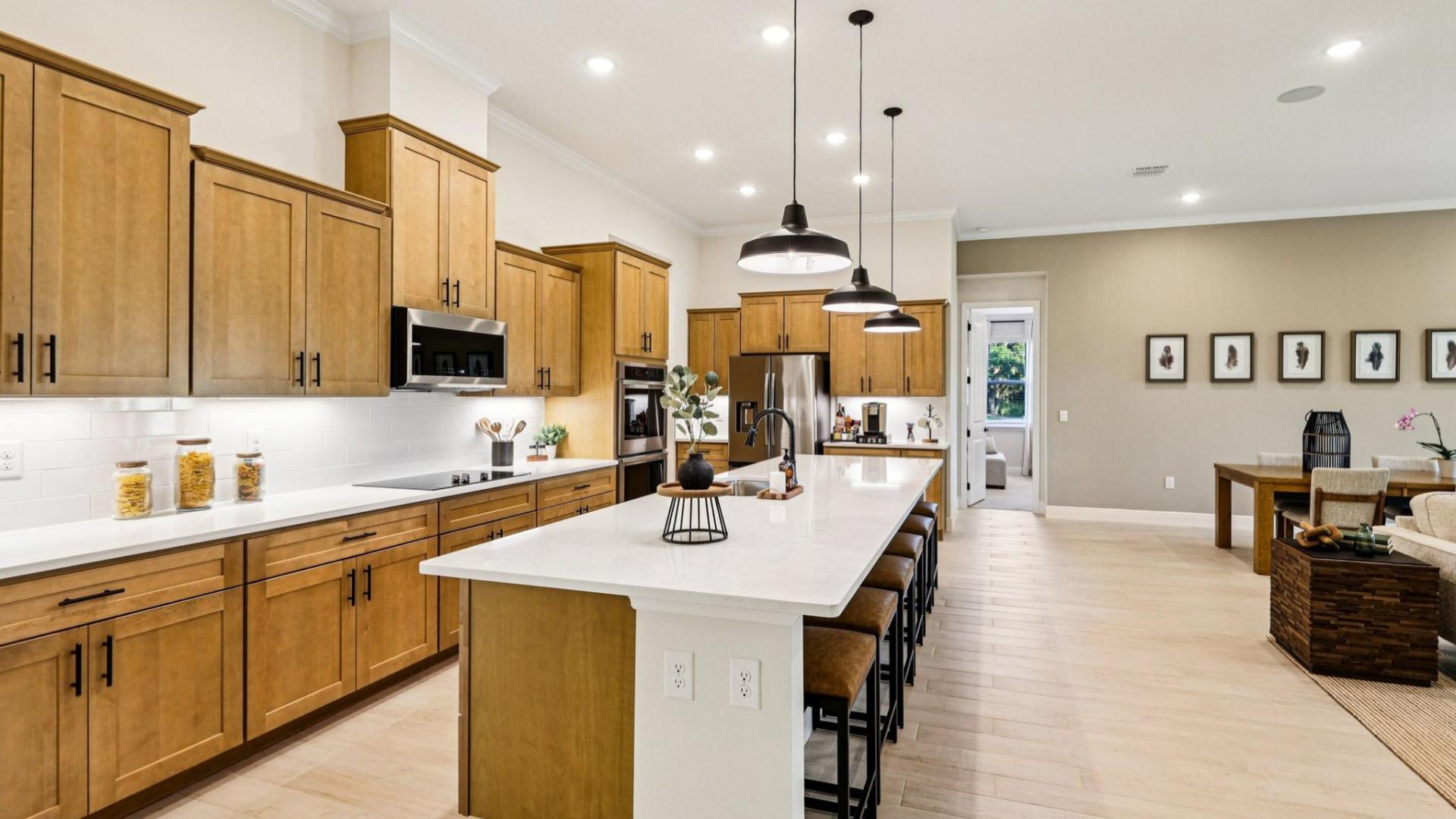 Spacious, functional kitchens with quartz countertops and LVP flooring.