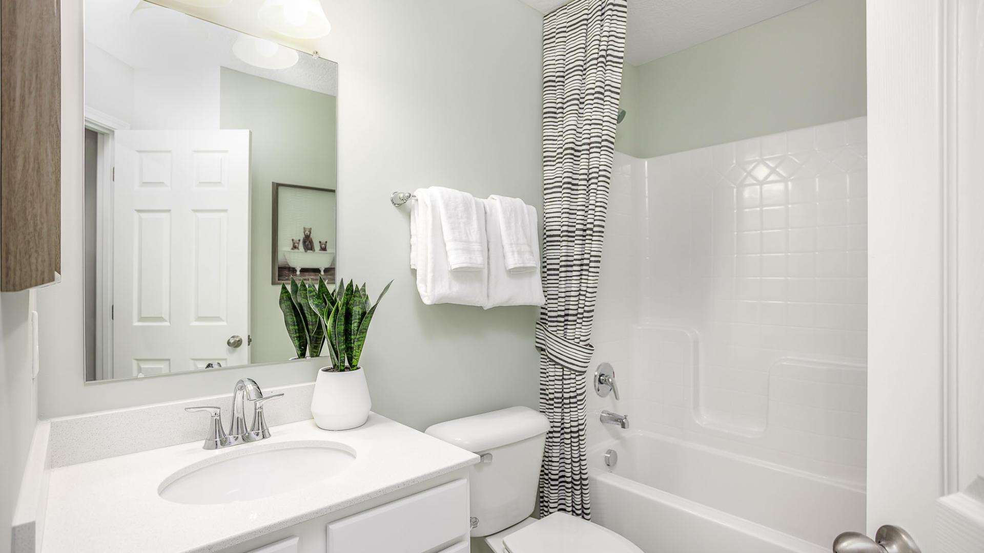 The guest bathroom ensures friends and family have their own space for comfort during visits.