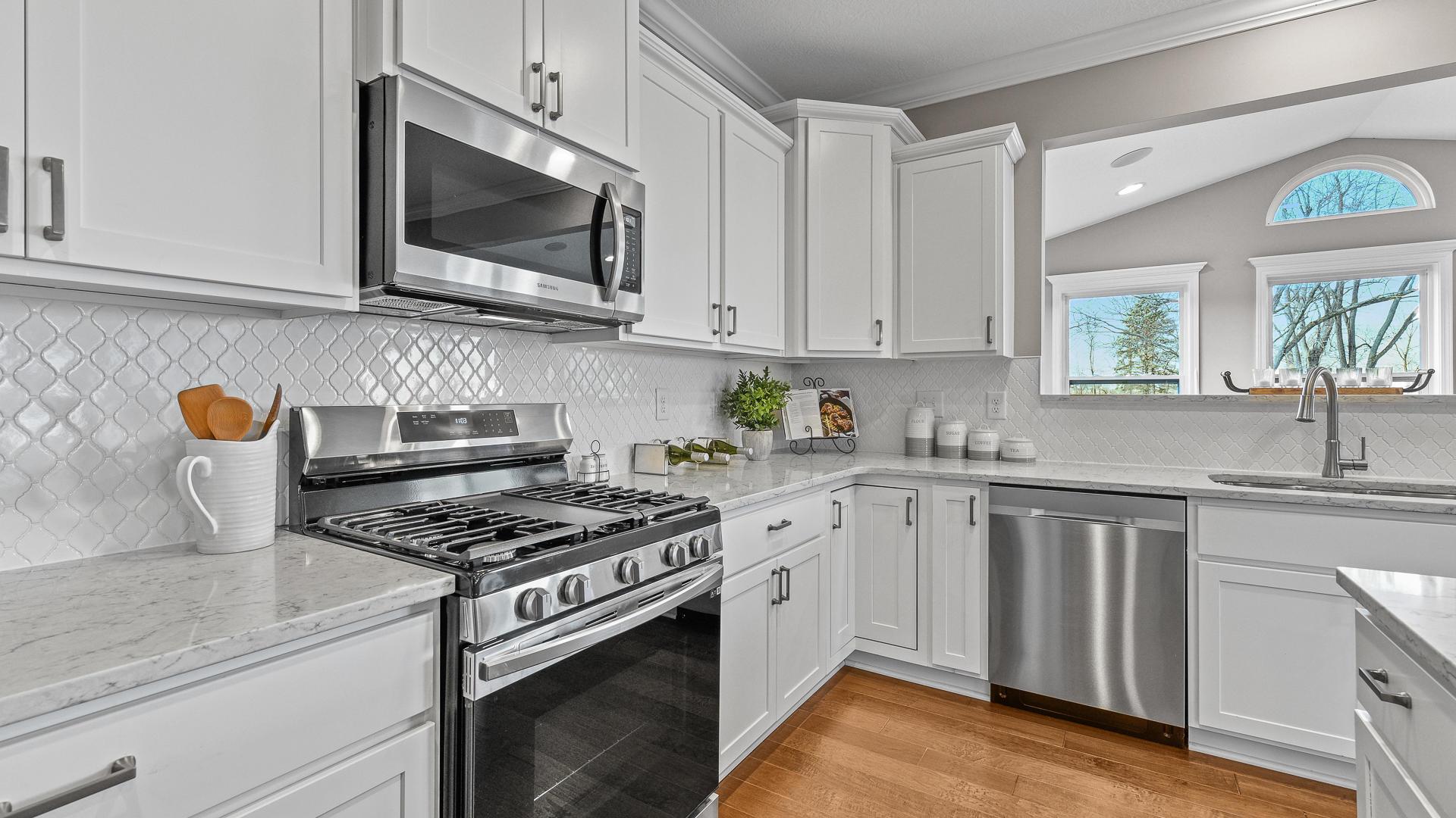 Your new kitchen has it all - Granite countertops, LVP flooring, and stainless steel appliances.