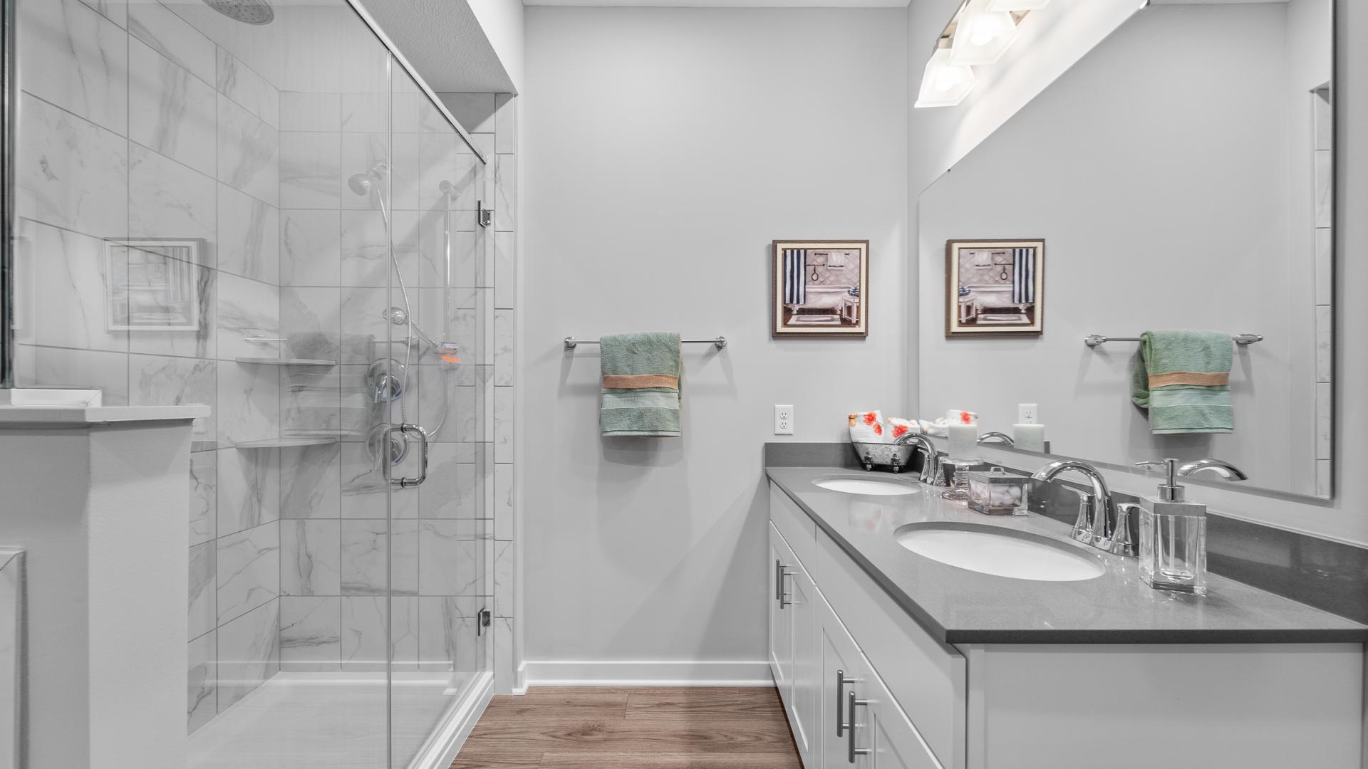 Dual vanities and a gorgeous walk-in shower turn your bathroom into an oasis.