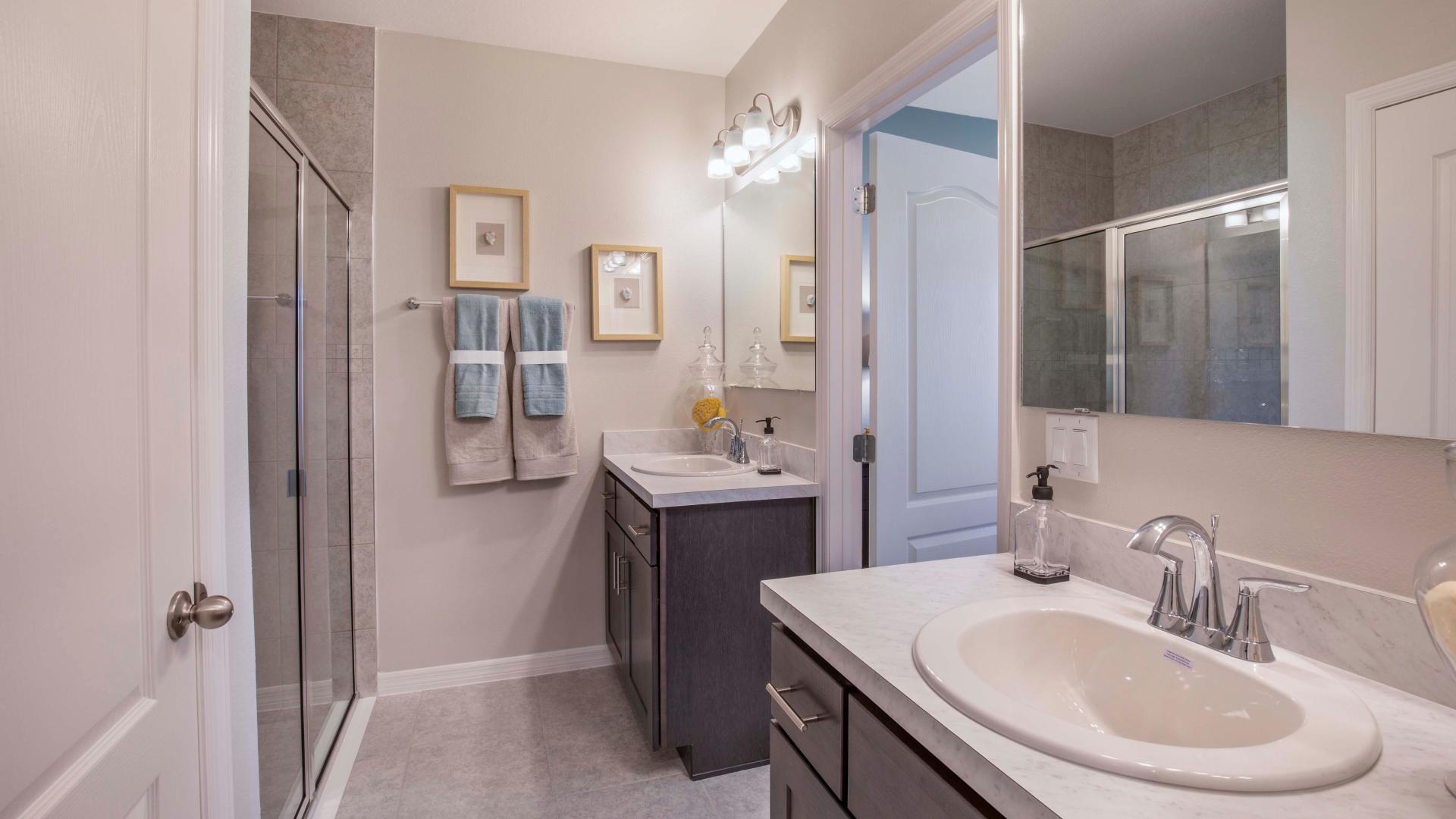 Dual vanities, frameless walk-in showers, and plenty of storage space in your master bath.