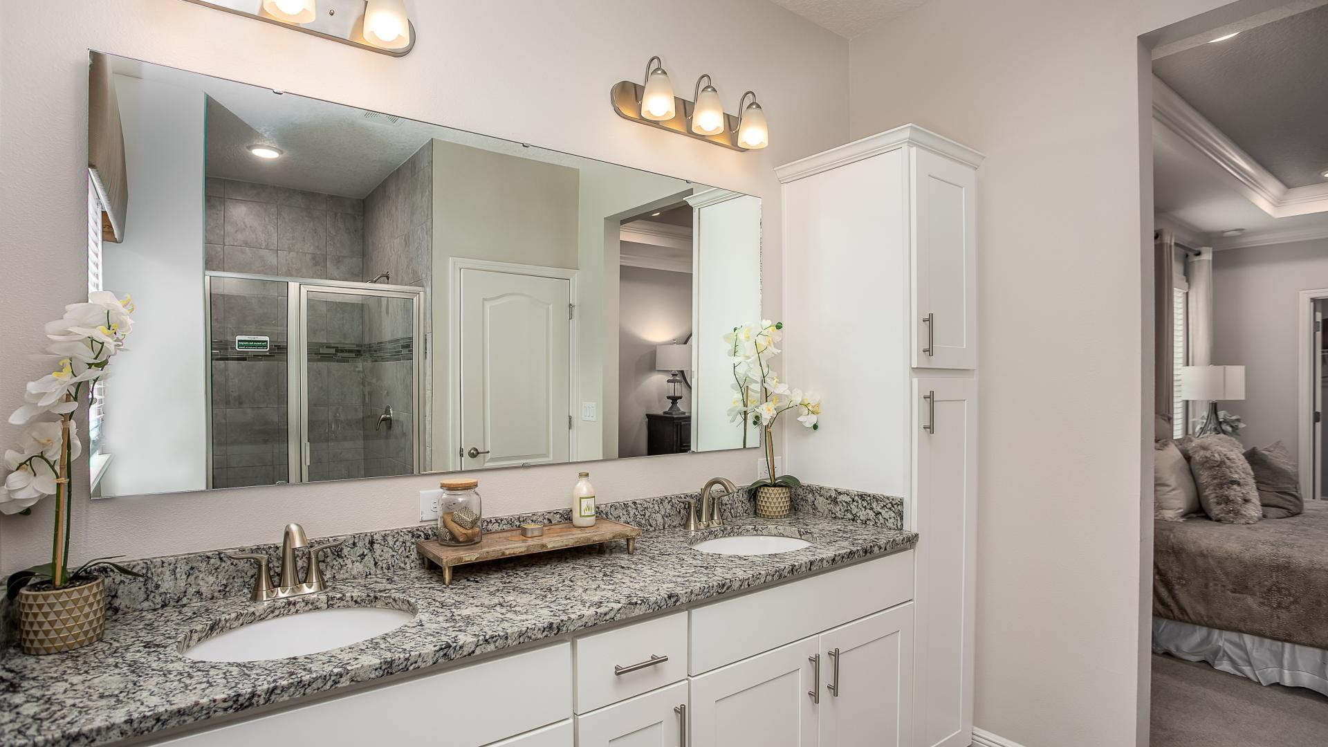 Dual vanities, walk-in tile surround showers and plenty of storage gives the master bath a spa like feel.