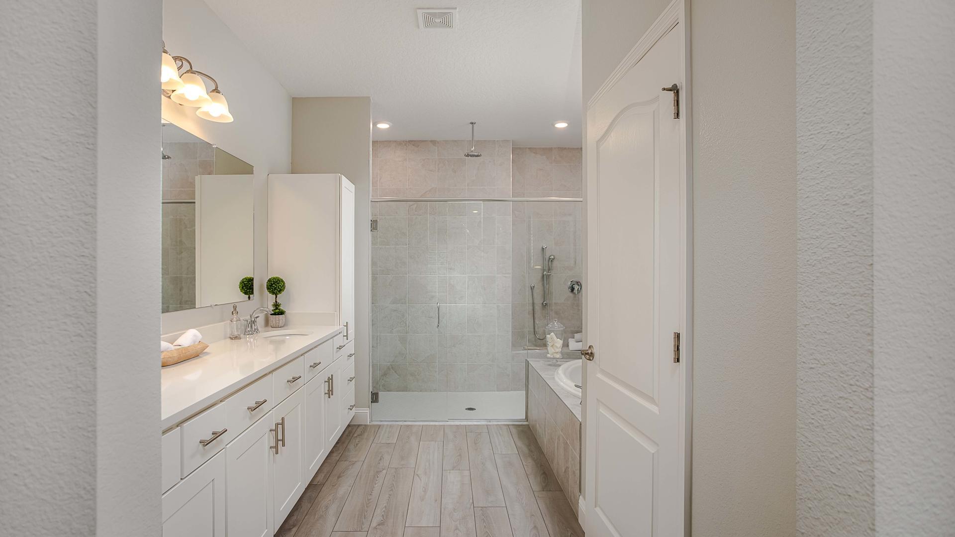 Dual vanities, walk-in tile surround showers and plenty of storage gives the master bath a spa like feel.