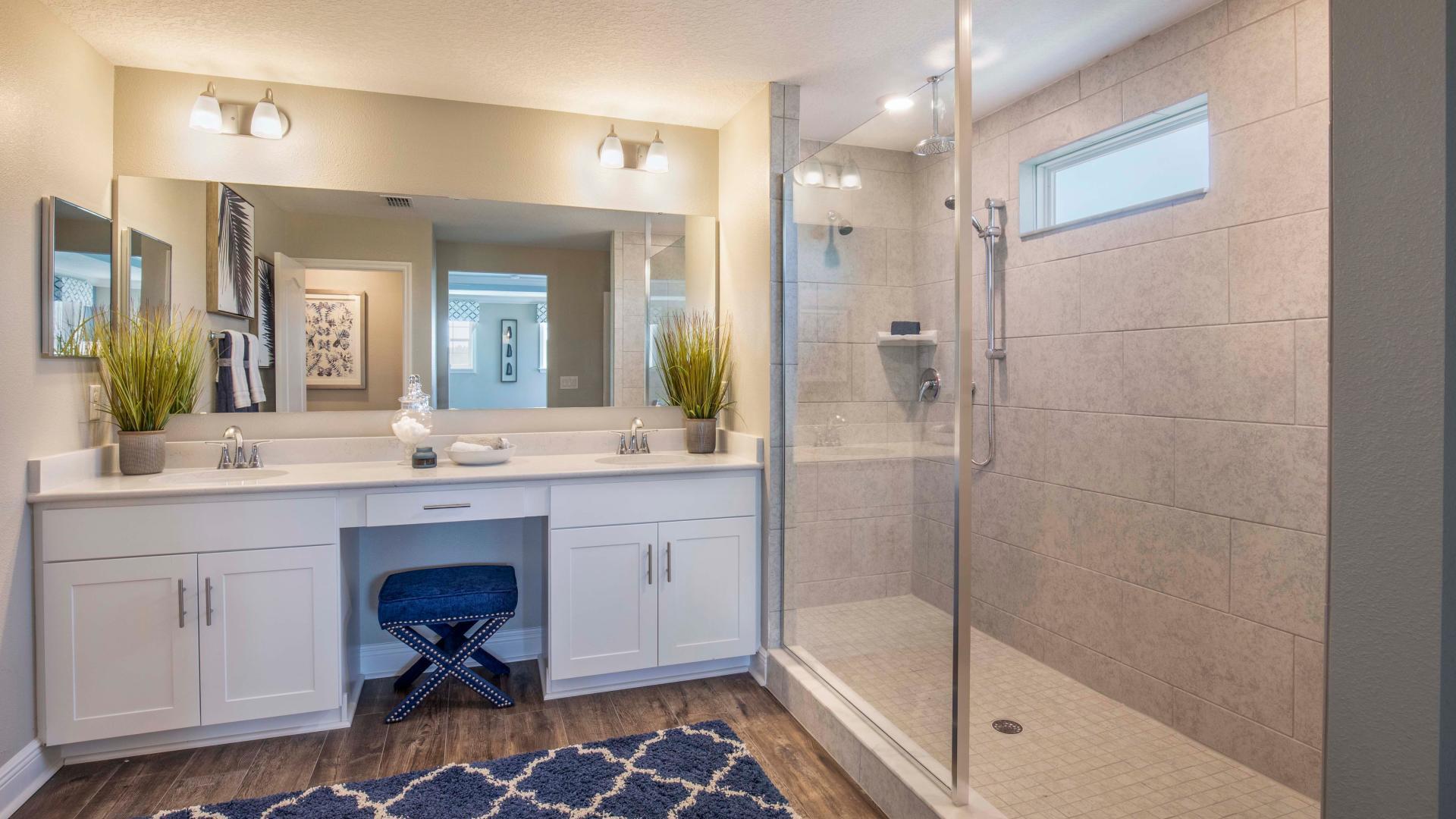 Dual vanities, walk-in tile surround showers and plenty of storage gives the master bath a spa like feel.