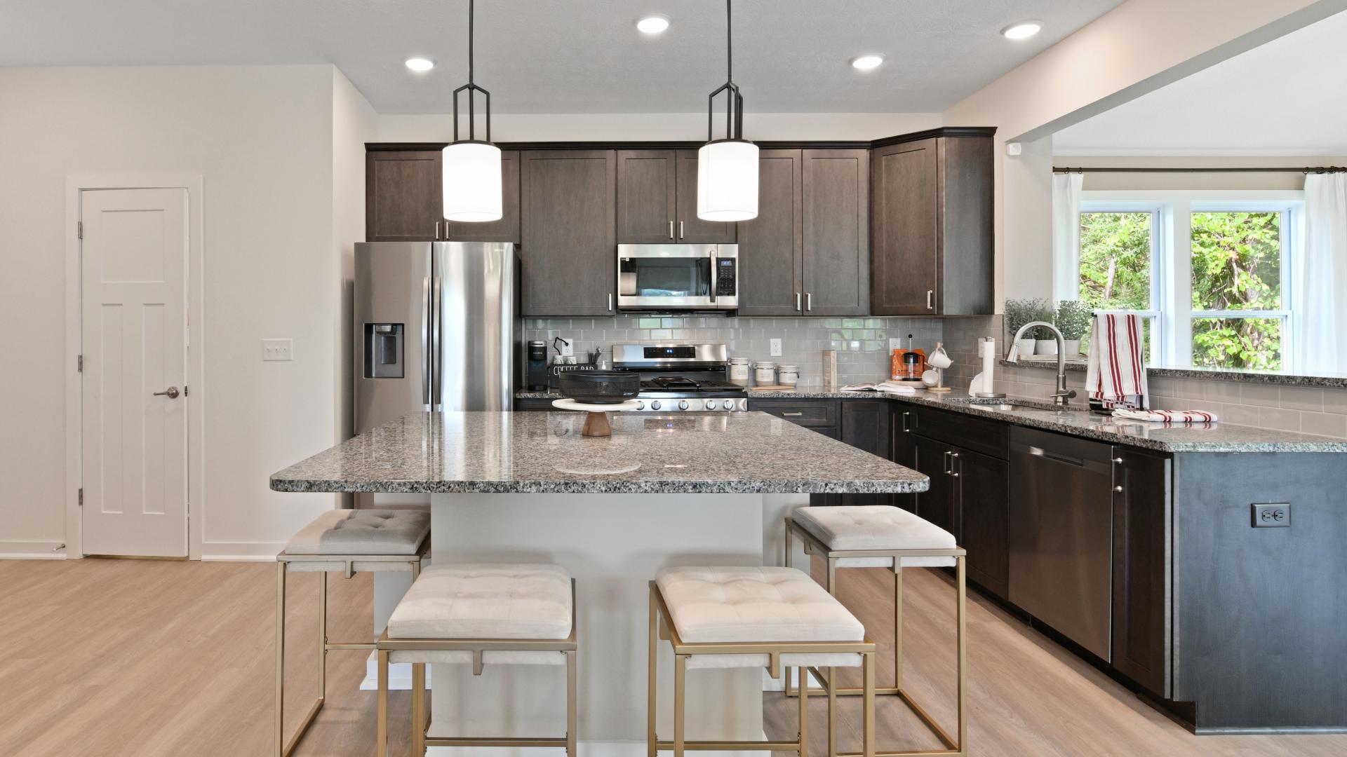 Your new kitchen has it all - Granite countertops, LVP flooring, and stainless steel appliances.