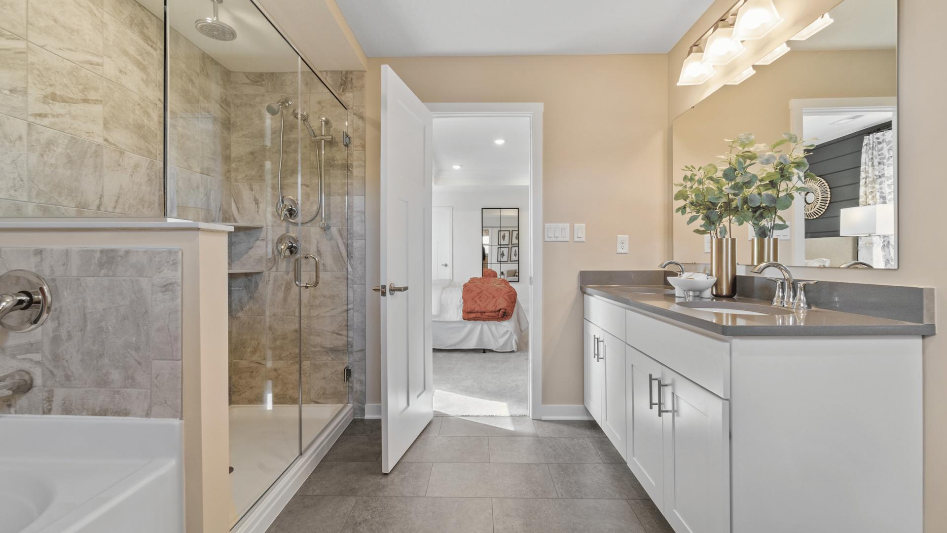 Live in luxury with a double vanity, walk-in shower, and bathtub.
