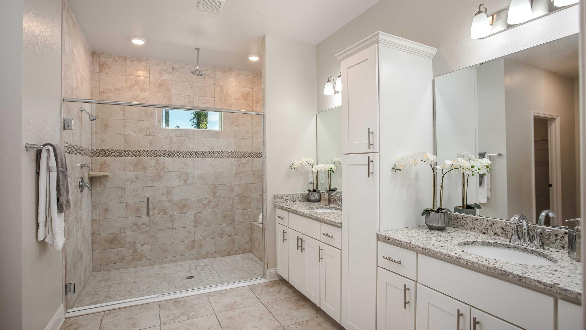 Dual vanities, frameless walk-in showers, and plenty of storage space in your master bath.