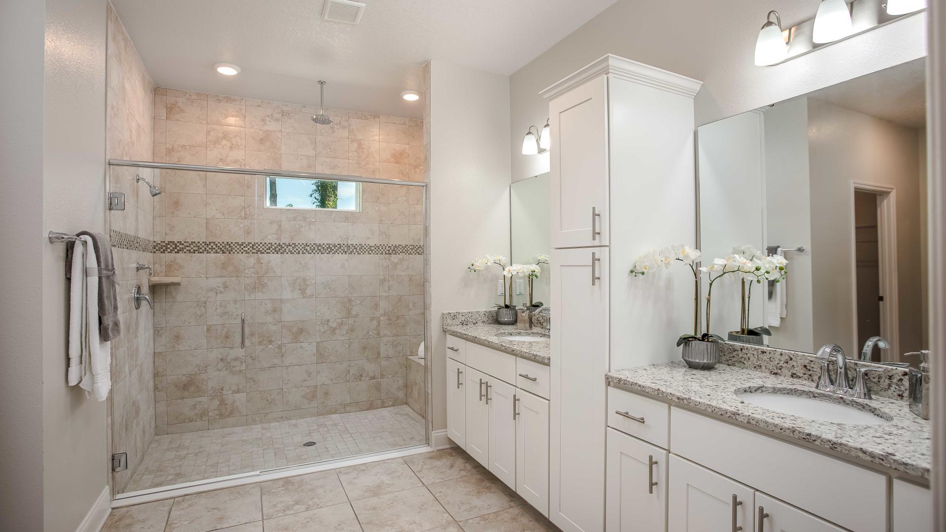 Dual vanities, walk-in tile surround showers and plenty of storage gives the master bath a spa like feel.