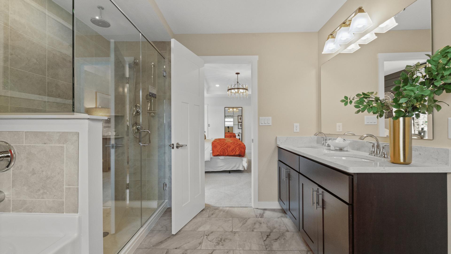 Dual vanities, frameless walk-in showers, and plenty of storage space in your master bath.
