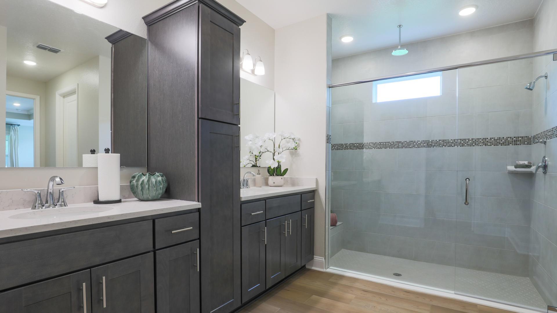 Dual vanities, walk-in tile surround showers and plenty of storage gives the master bath a spa like feel.