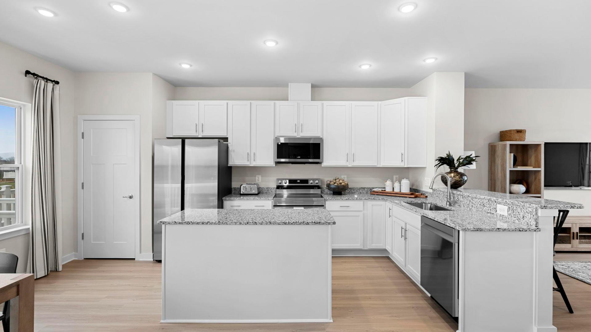 Your new kitchen has it all - Granite countertops, LVP flooring, and stainless steel appliances.