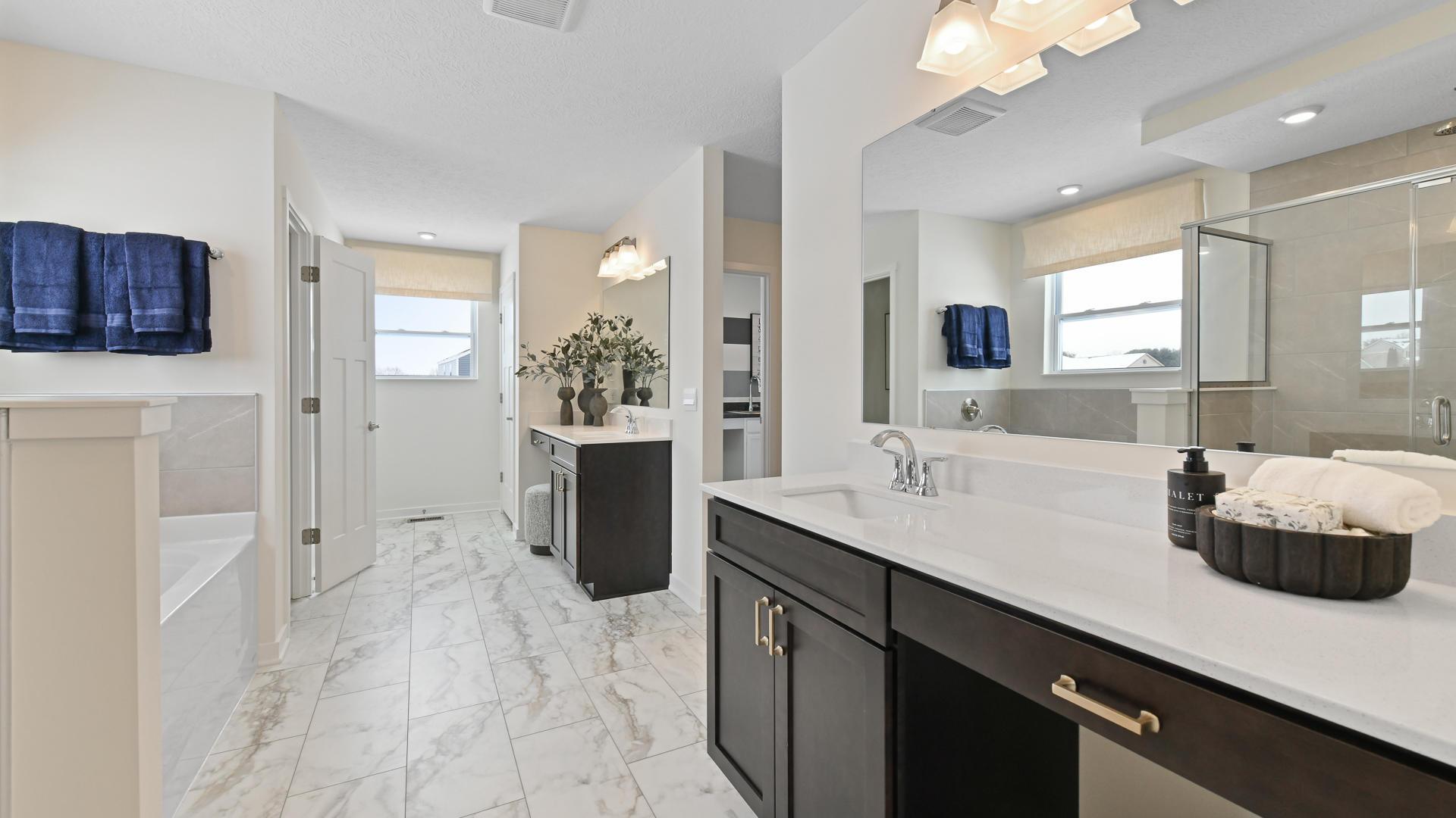 Walk-in shower and dual vanities included on most floor plans.