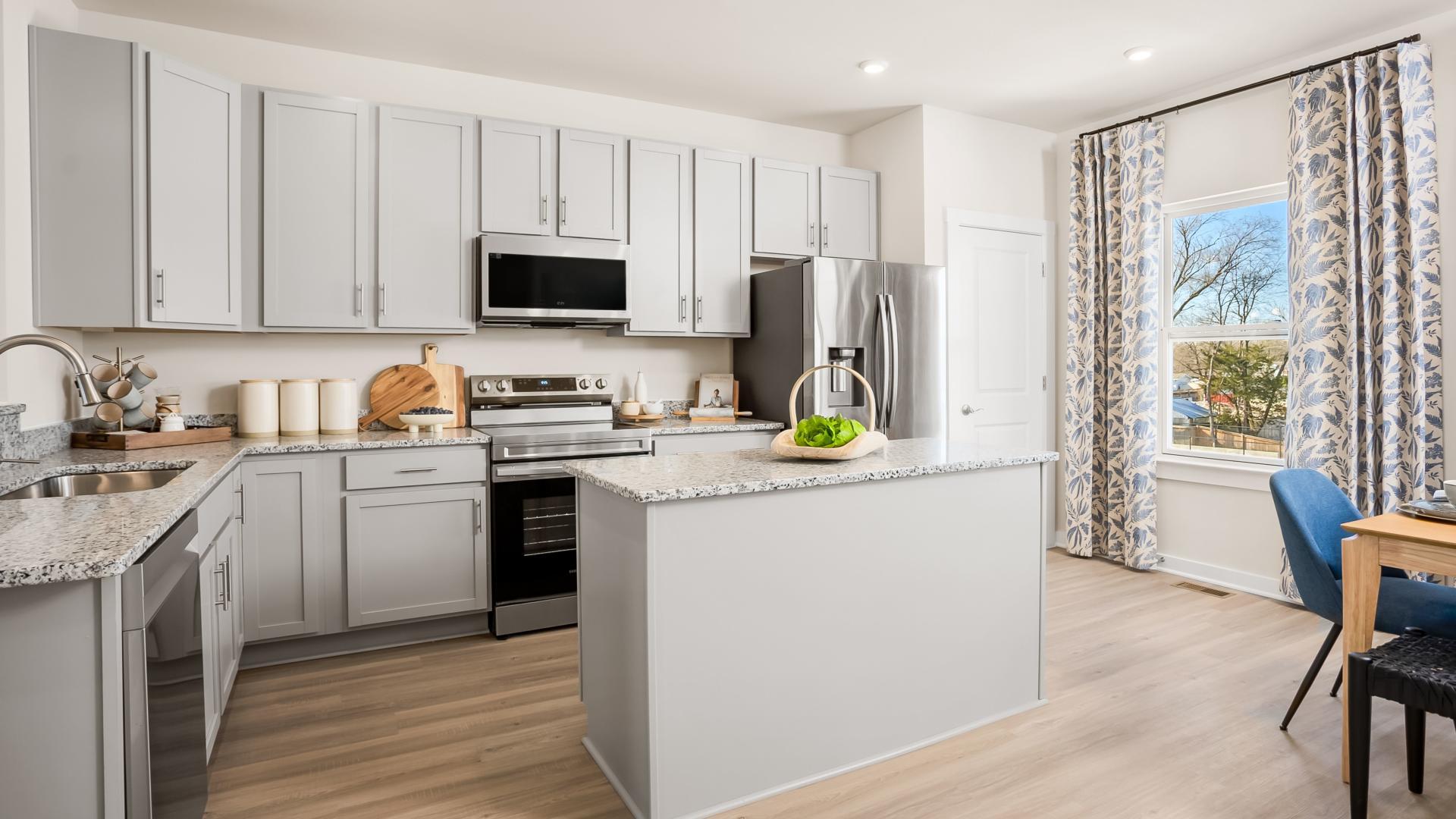 Kitchens include stainless steel appliances, granite countertops, and LVP flooring.