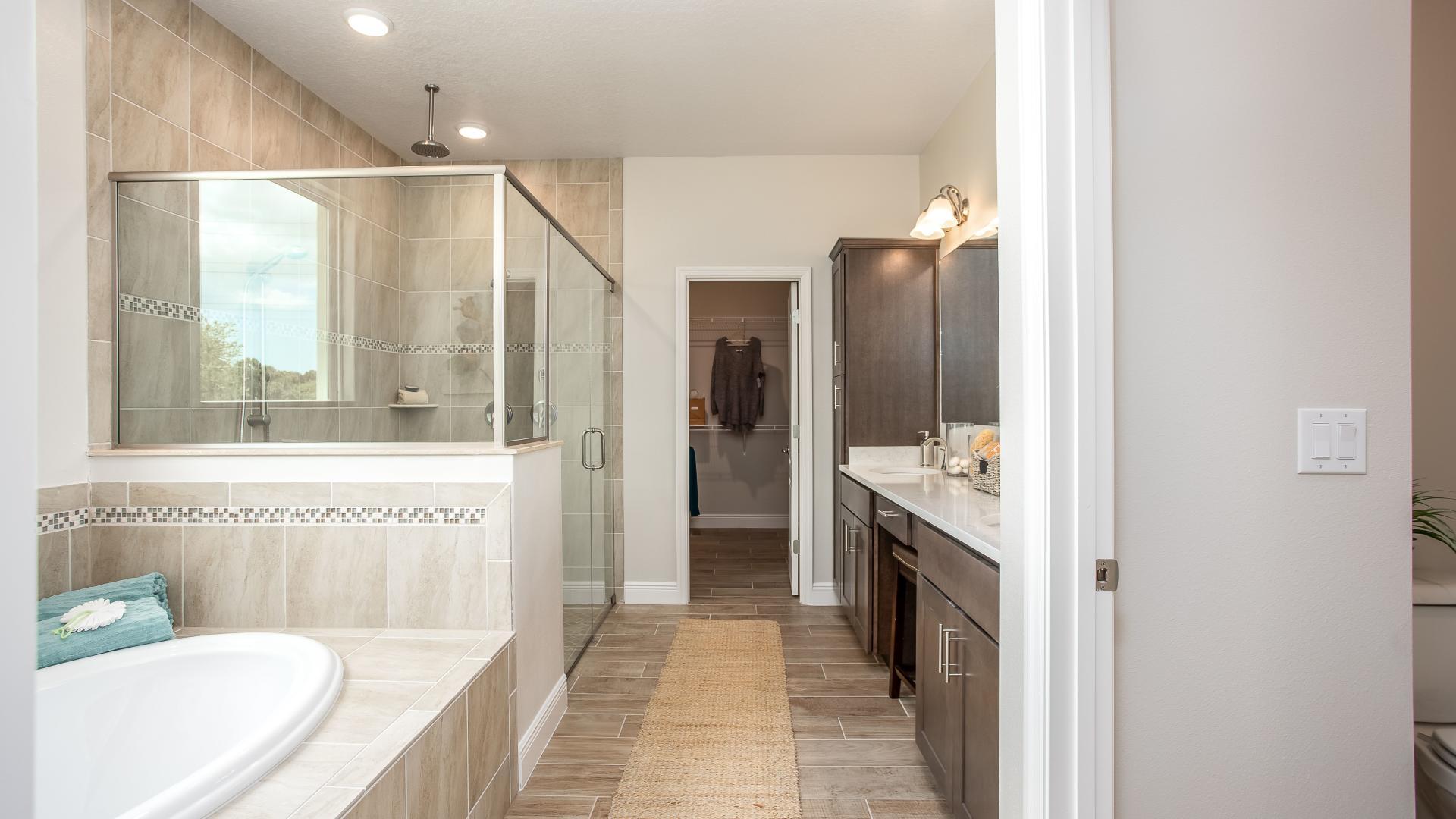 Revel in your spa-like master bathroom with frameless, walk-in shower and soak tub.
