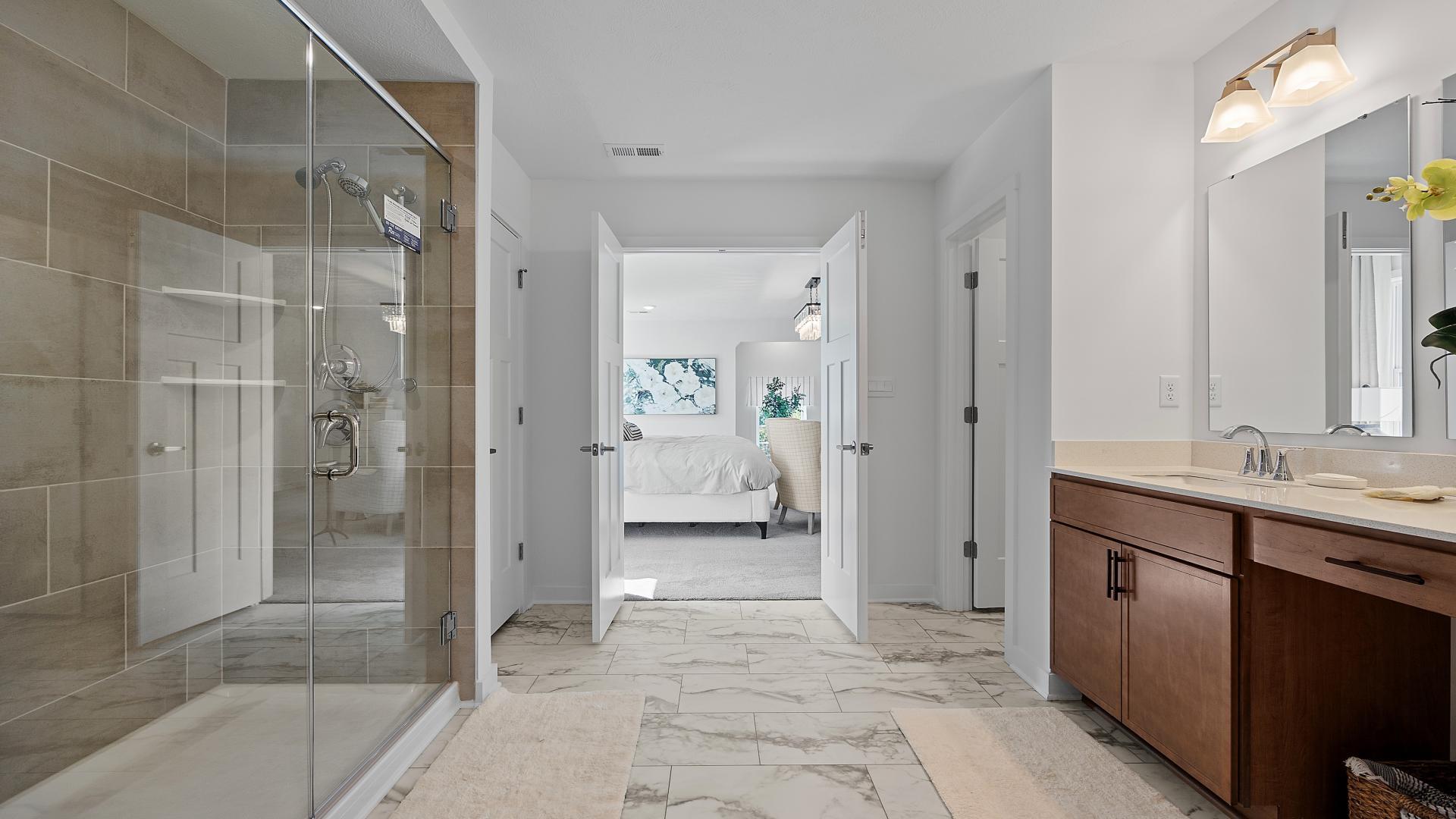 Have a spa-like bath with rainfall shower and frameless doors.