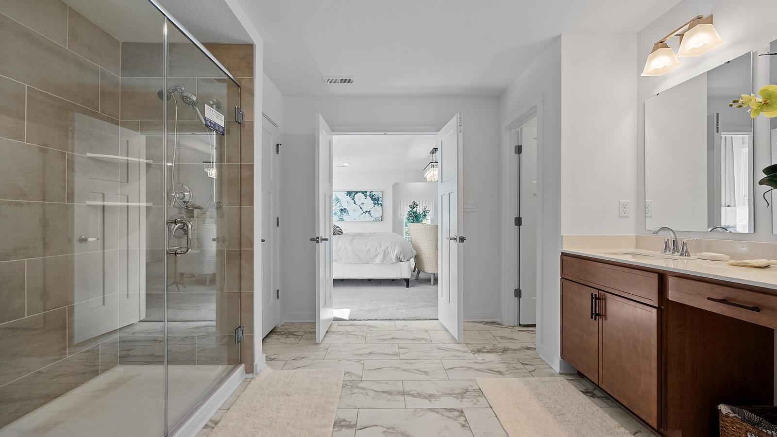 Have a spa-like bath with rainfall shower and frameless doors.