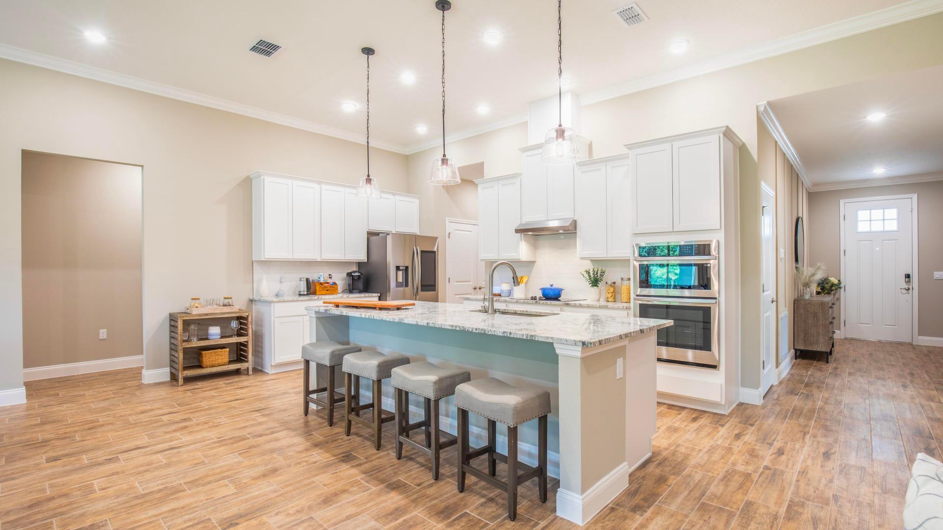 Whip up a quick meal with a double oven and a spacious quartz countertop in your chef’s kitchen.