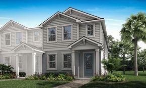 New townhome with Florida landscaping and bright blue sky