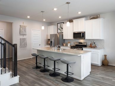 Prep dinner without missing a moment in this open concept.