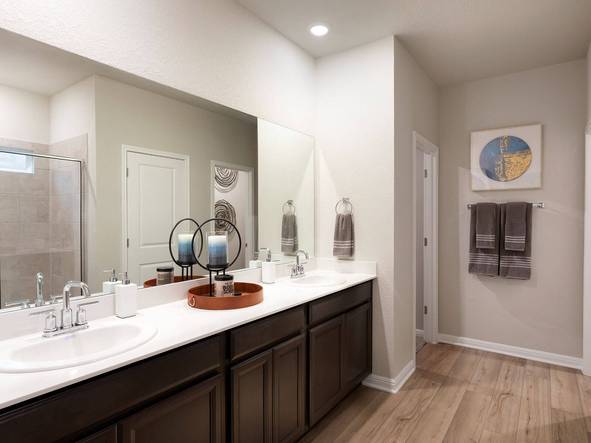 The primary bathroom includes dual-sinks and a walk-in shower.