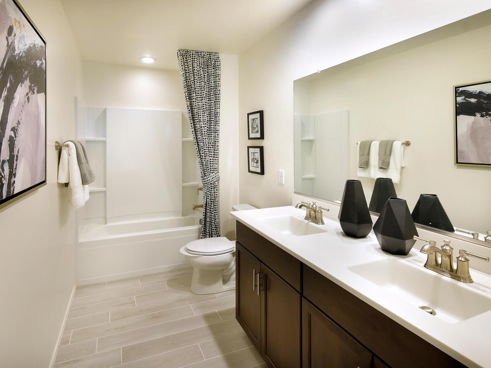 The secondary upstairs bathroom boasts dual sinks.