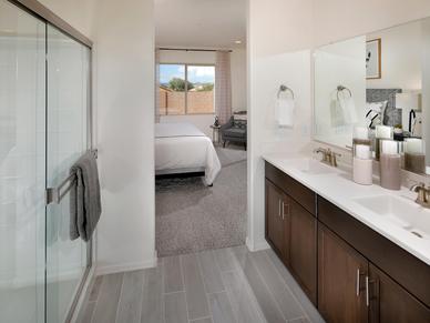 The primary suite boasts a private ensuite bathroom with dual sinks and a spacious walk-in closet.