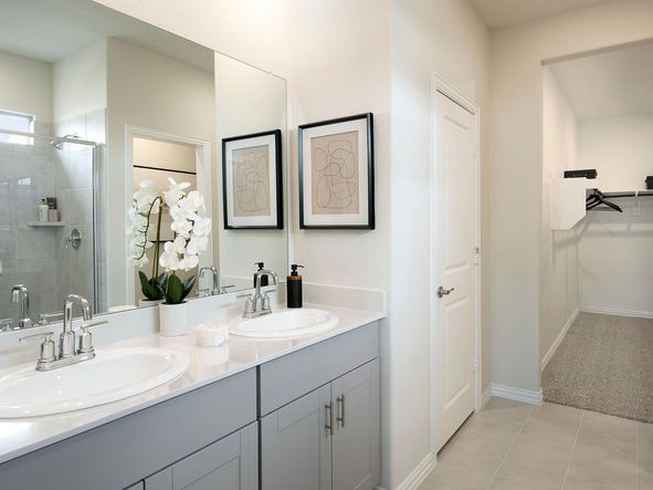 Your primary bathroom retreat features double vanities