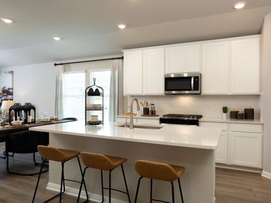 The Divine interior package features off-white quartz countertops and brown grey EVP flooring.