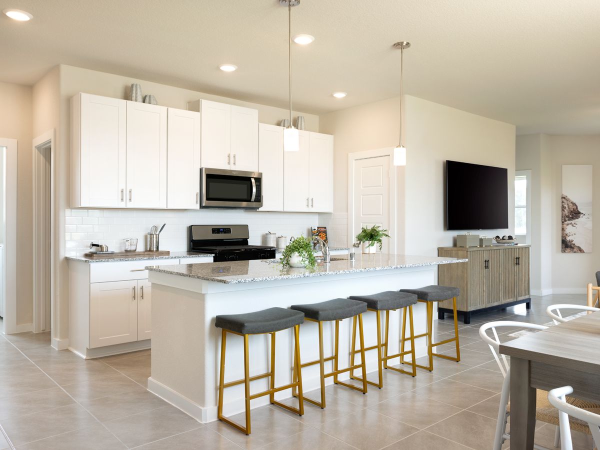 Prep dinner without missing a moment in this open concept.