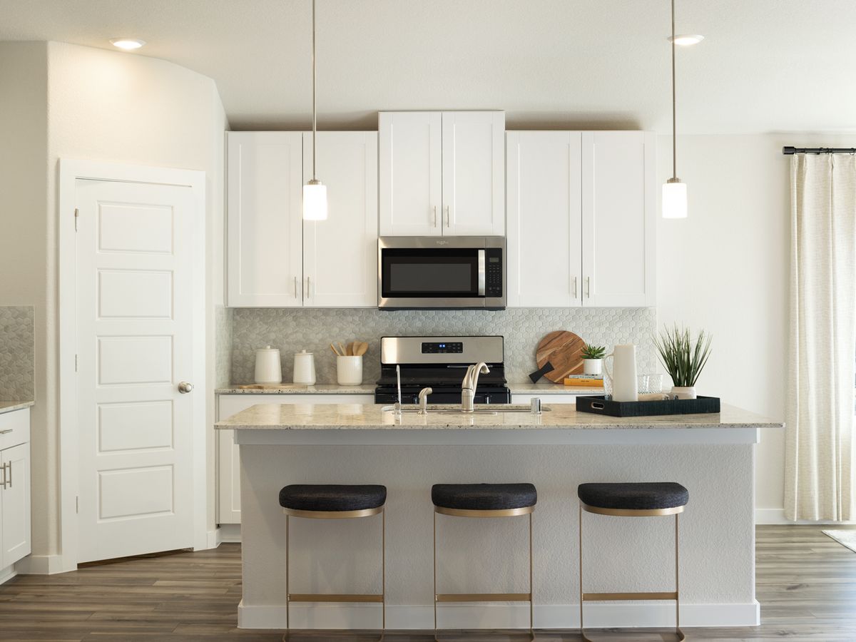 Prep dinner without missing a moment in this open concept.