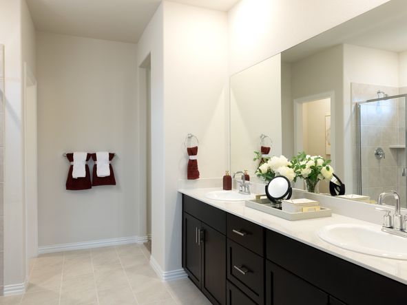 Your primary bathroom retreat features double vanities
