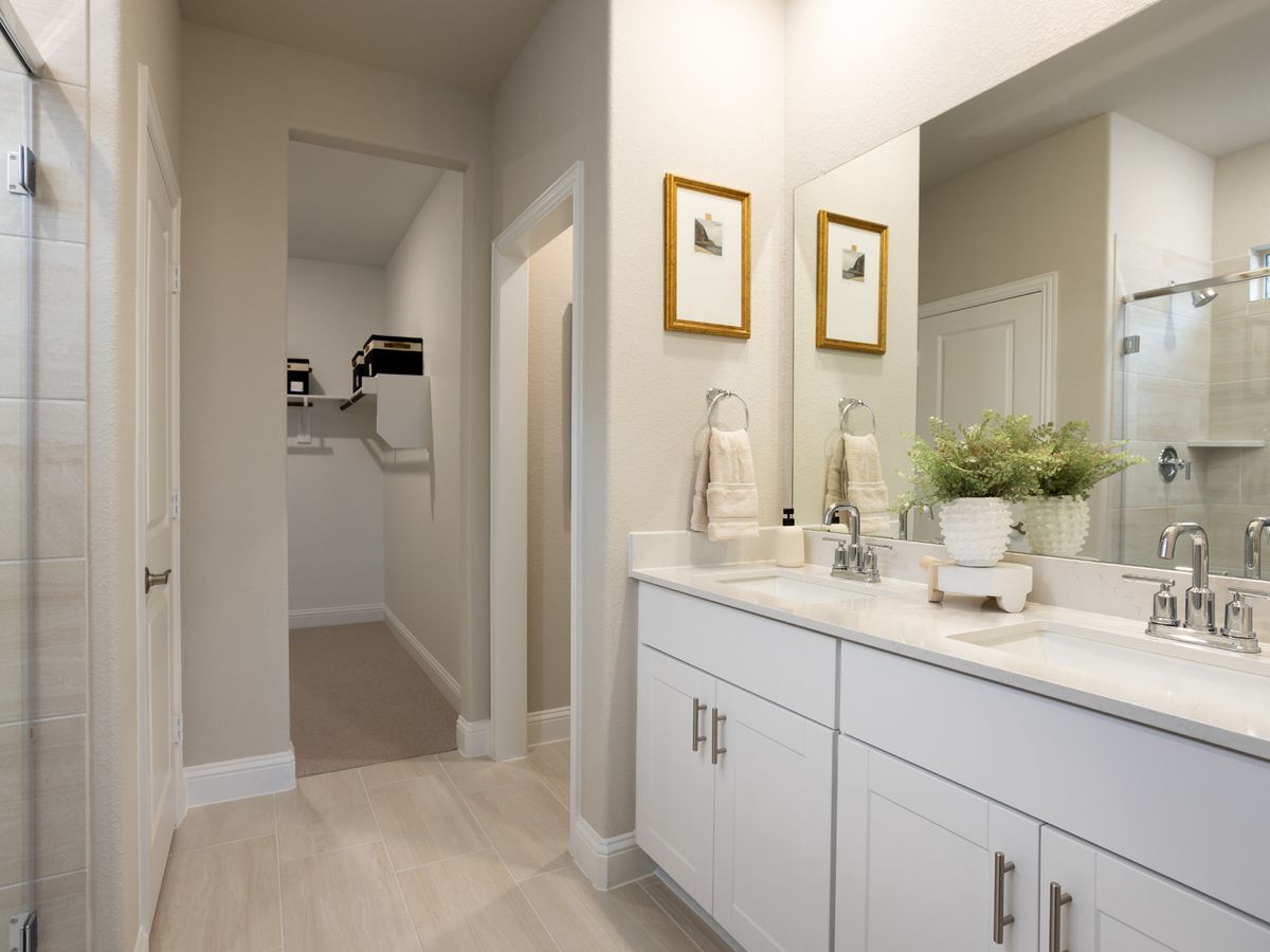 Your primary bathroom retreat features double vanities