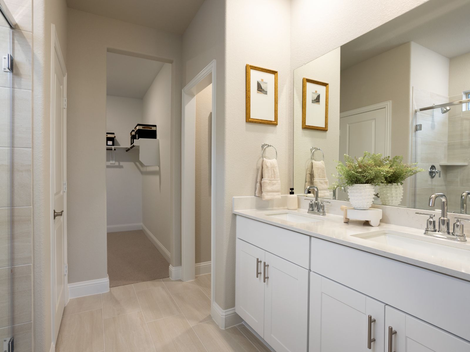 Your primary bathroom retreat features double vanities