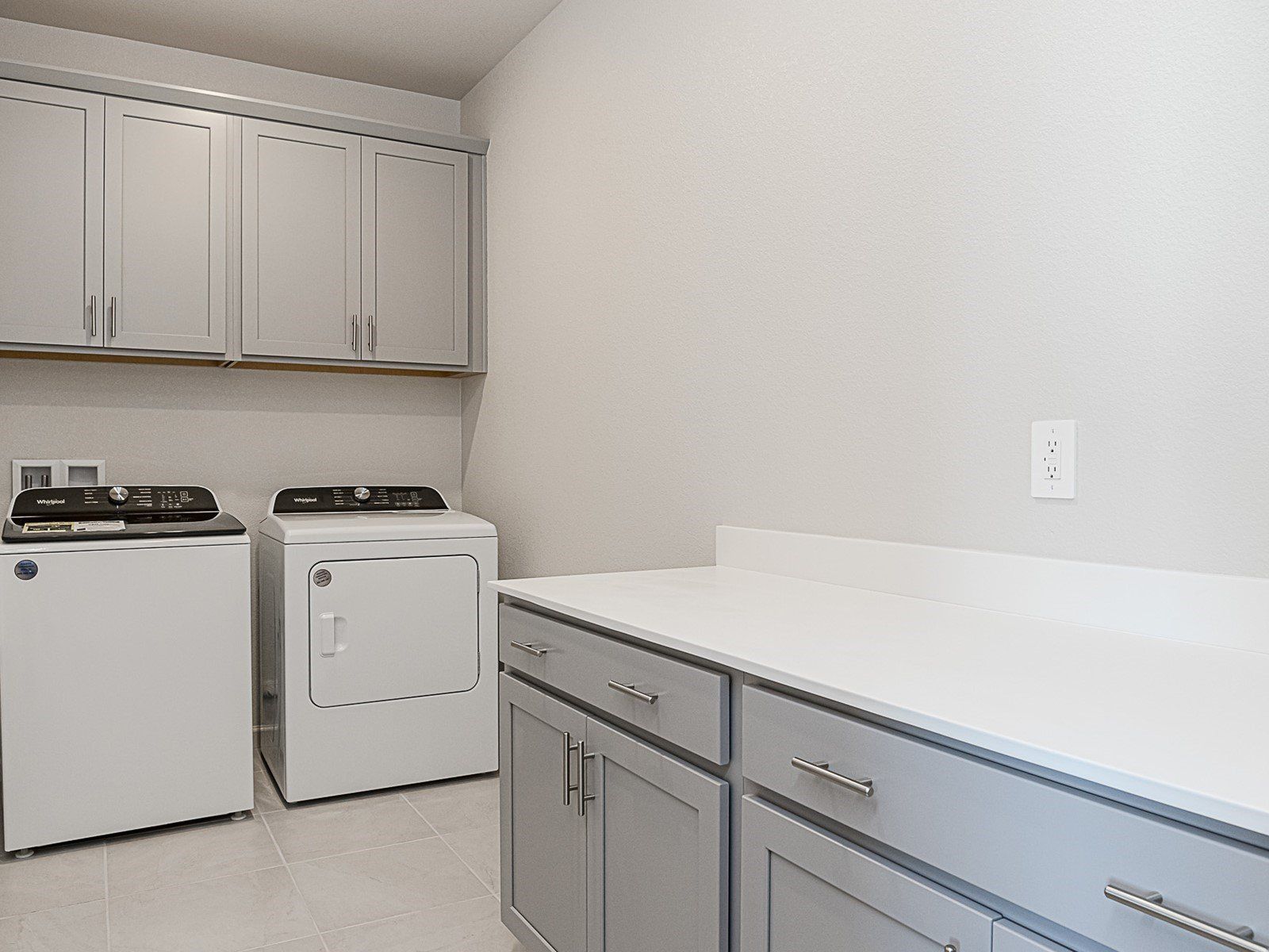 Spacious laundry room with plenty of storage.
