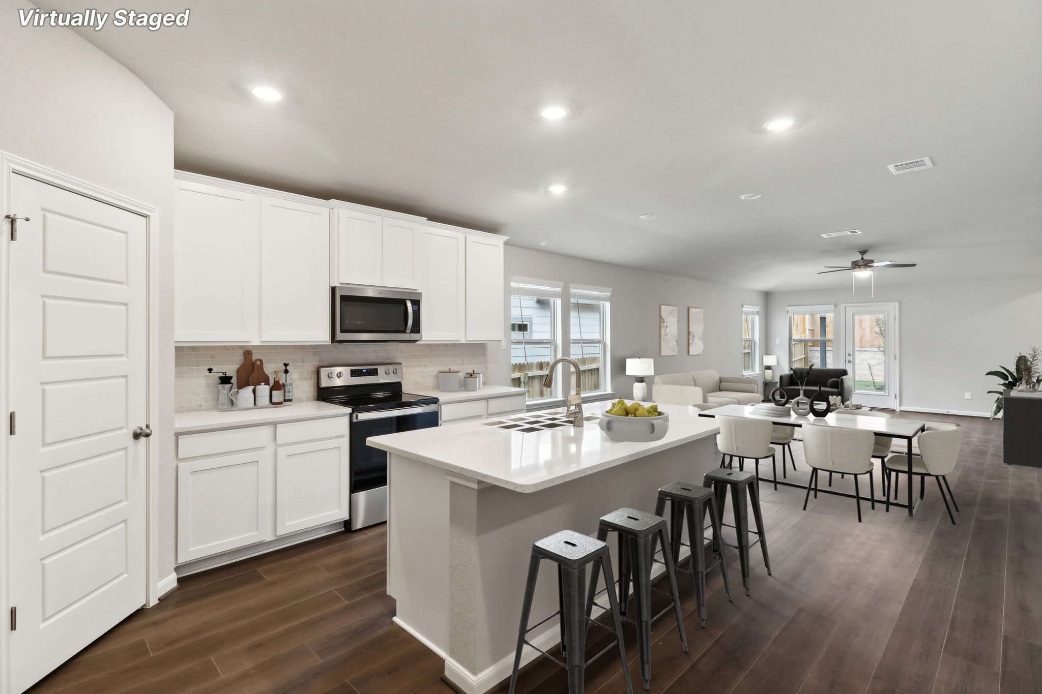 Virtually staged kitchen, dining, and living room in the Hughes floorplan.