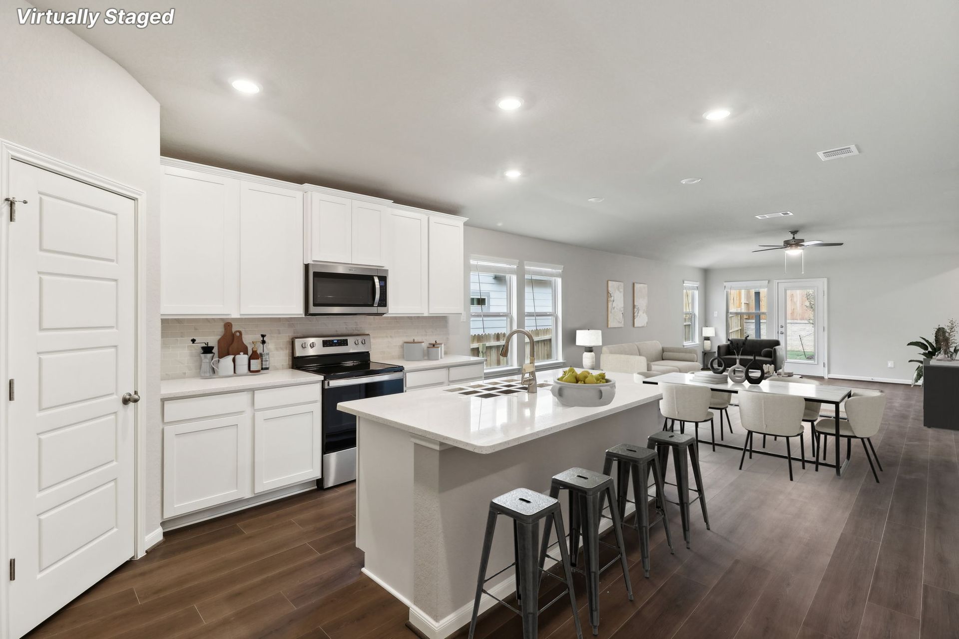 Virtually staged kitchen, dining, and living room in the Hughes floorplan.