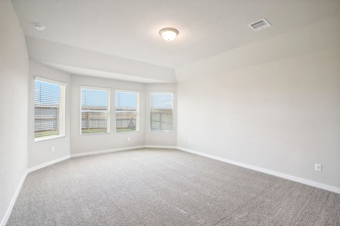The primary bedroom of a home in Wall Street Village of Richmond, TX.
