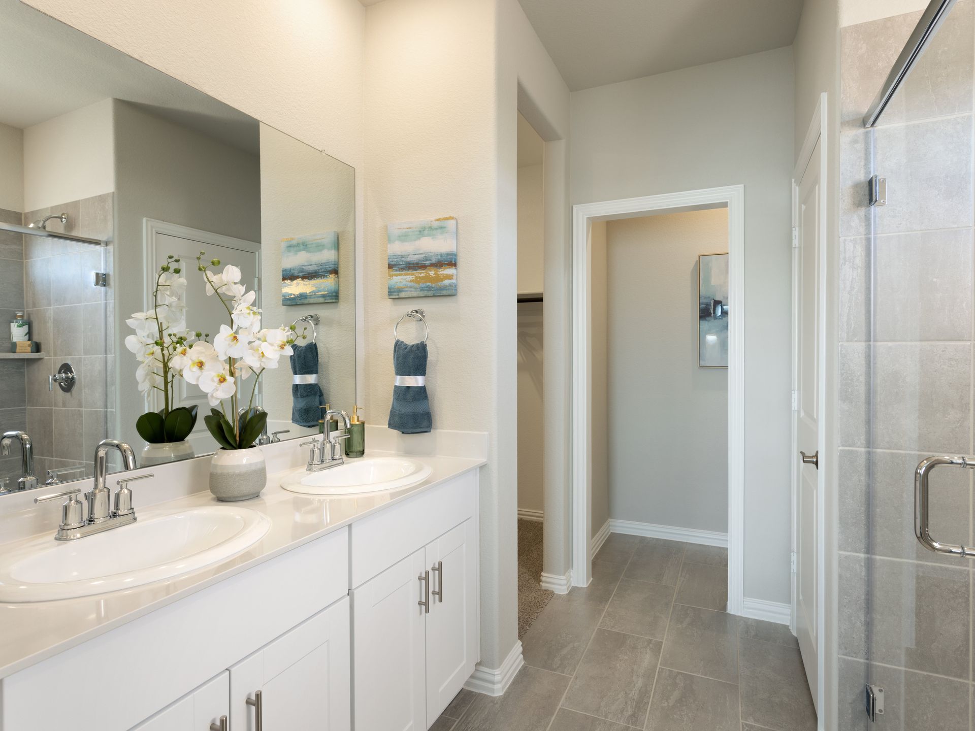 Your primary bathroom retreat features double vanities