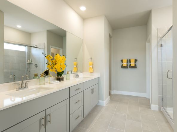 Your primary bathroom retreat features double vanities