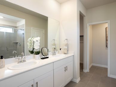 Your primary bathroom retreat features double vanities
