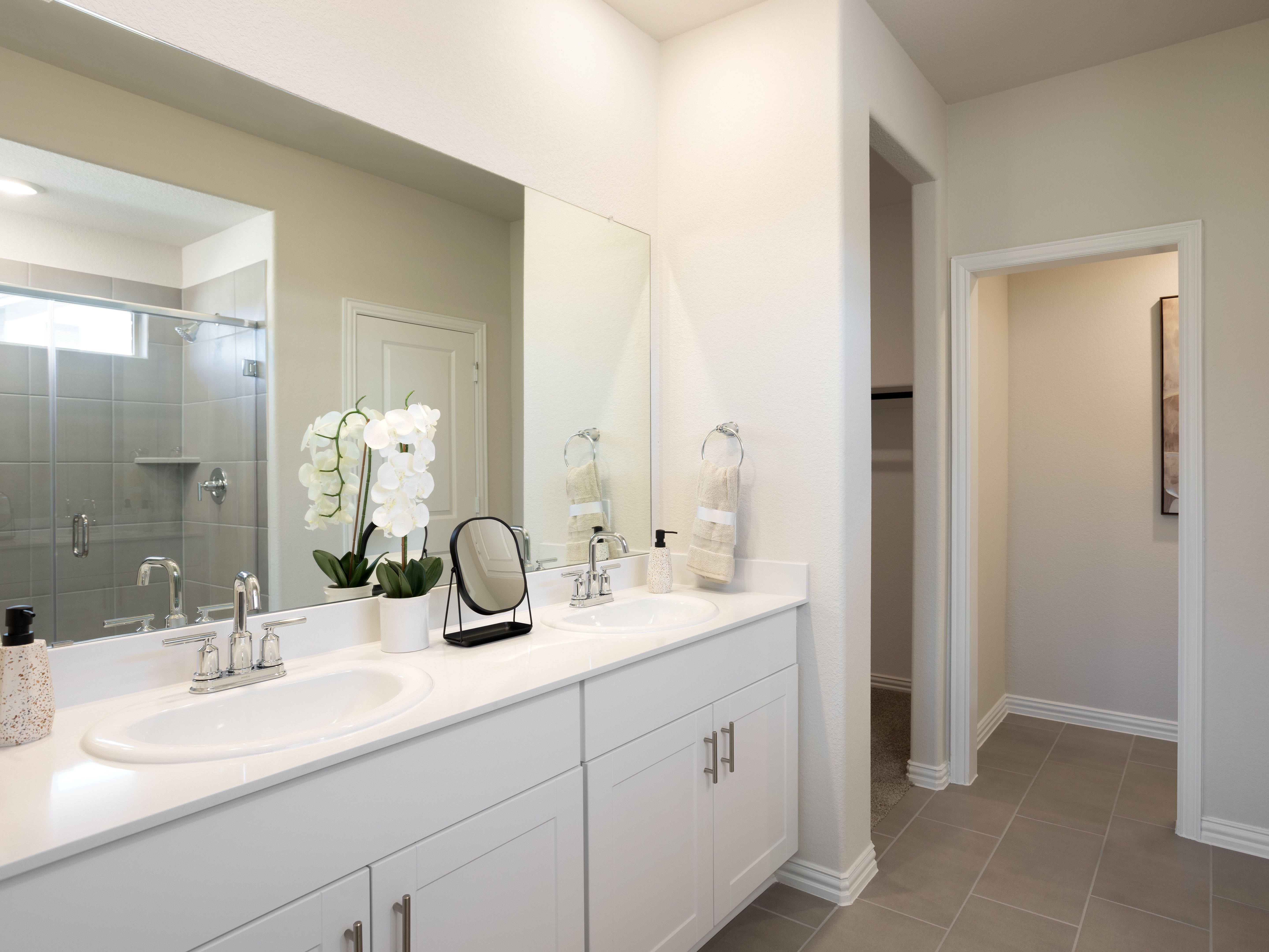 Your primary bathroom retreat features double vanities