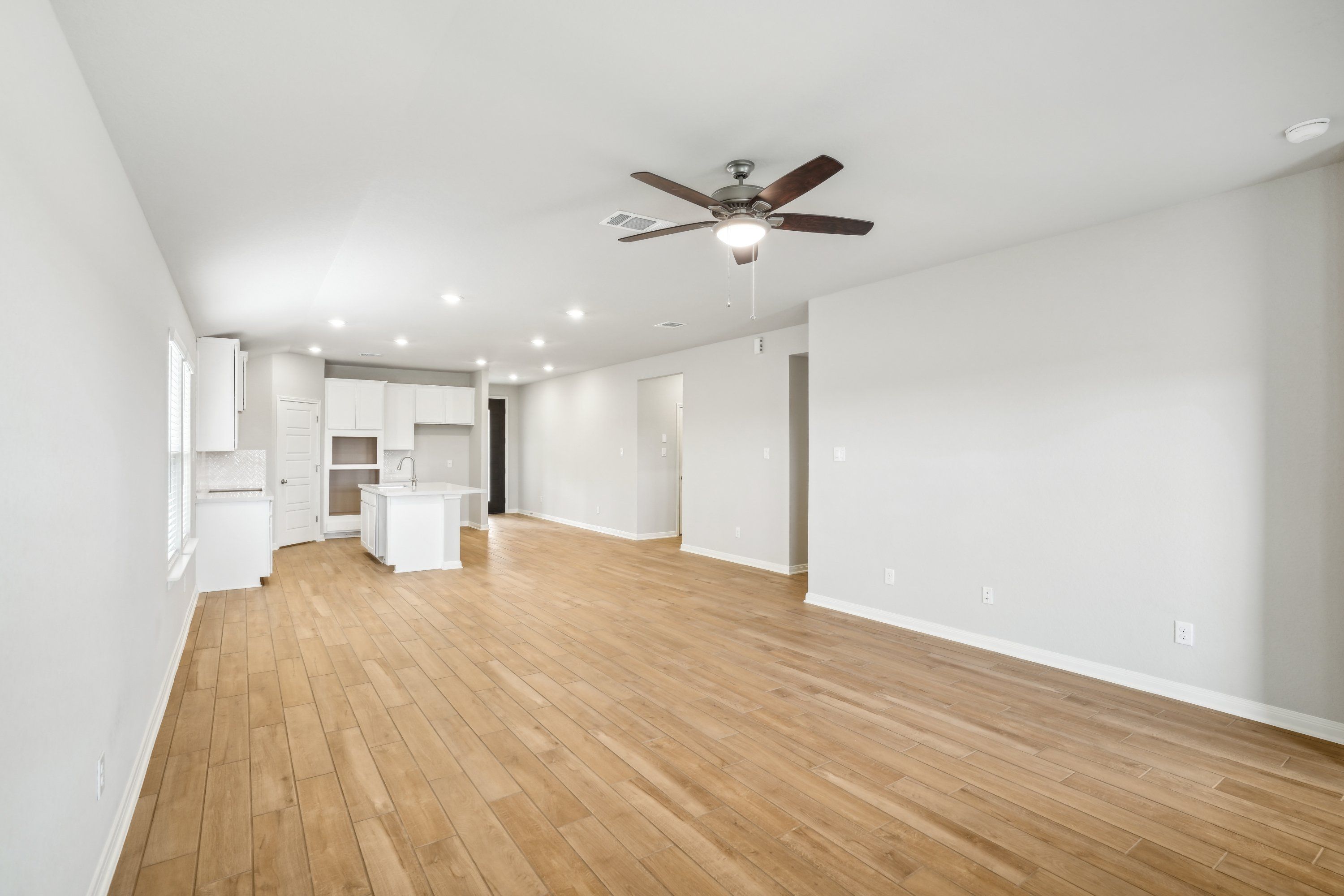 Dining room and kitchen in the Oleander floorplan at a Meritage Homes community.