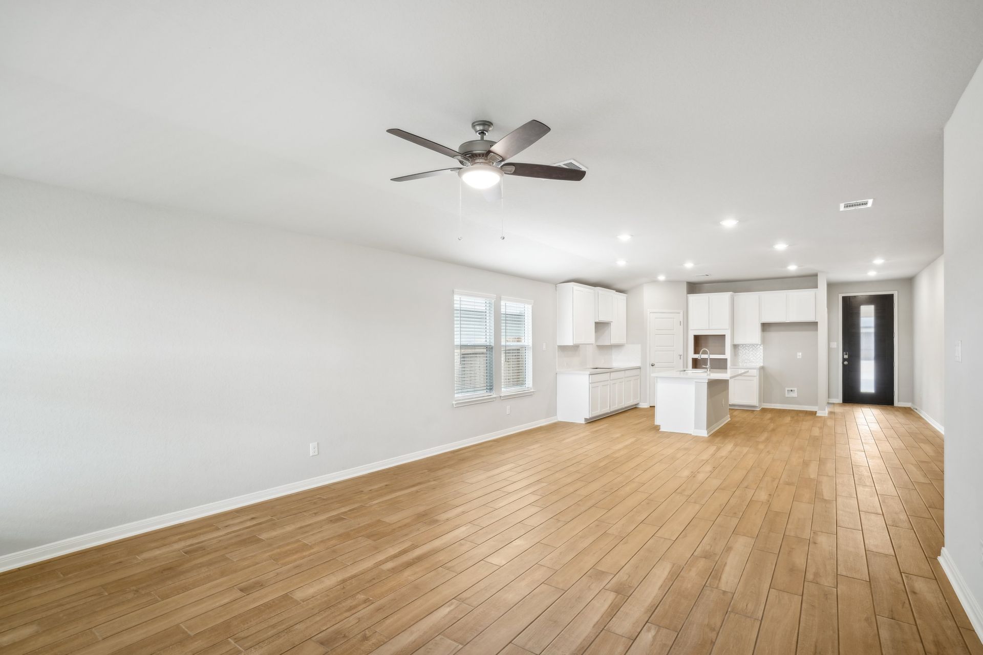 Dining room and kitchen in the Oleander floorplan at a Meritage Homes community.