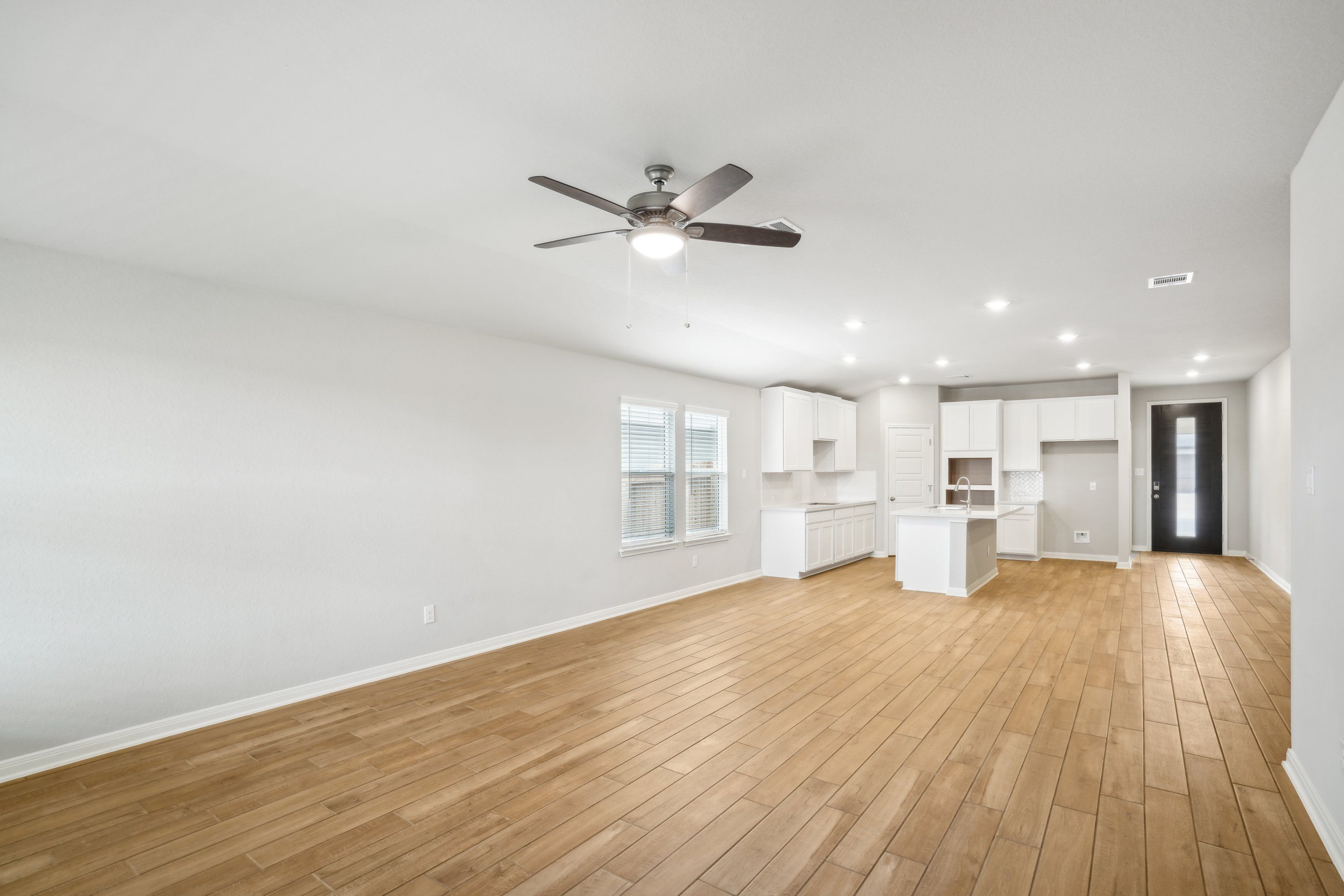 Dining room and kitchen in the Oleander floorplan at a Meritage Homes community.