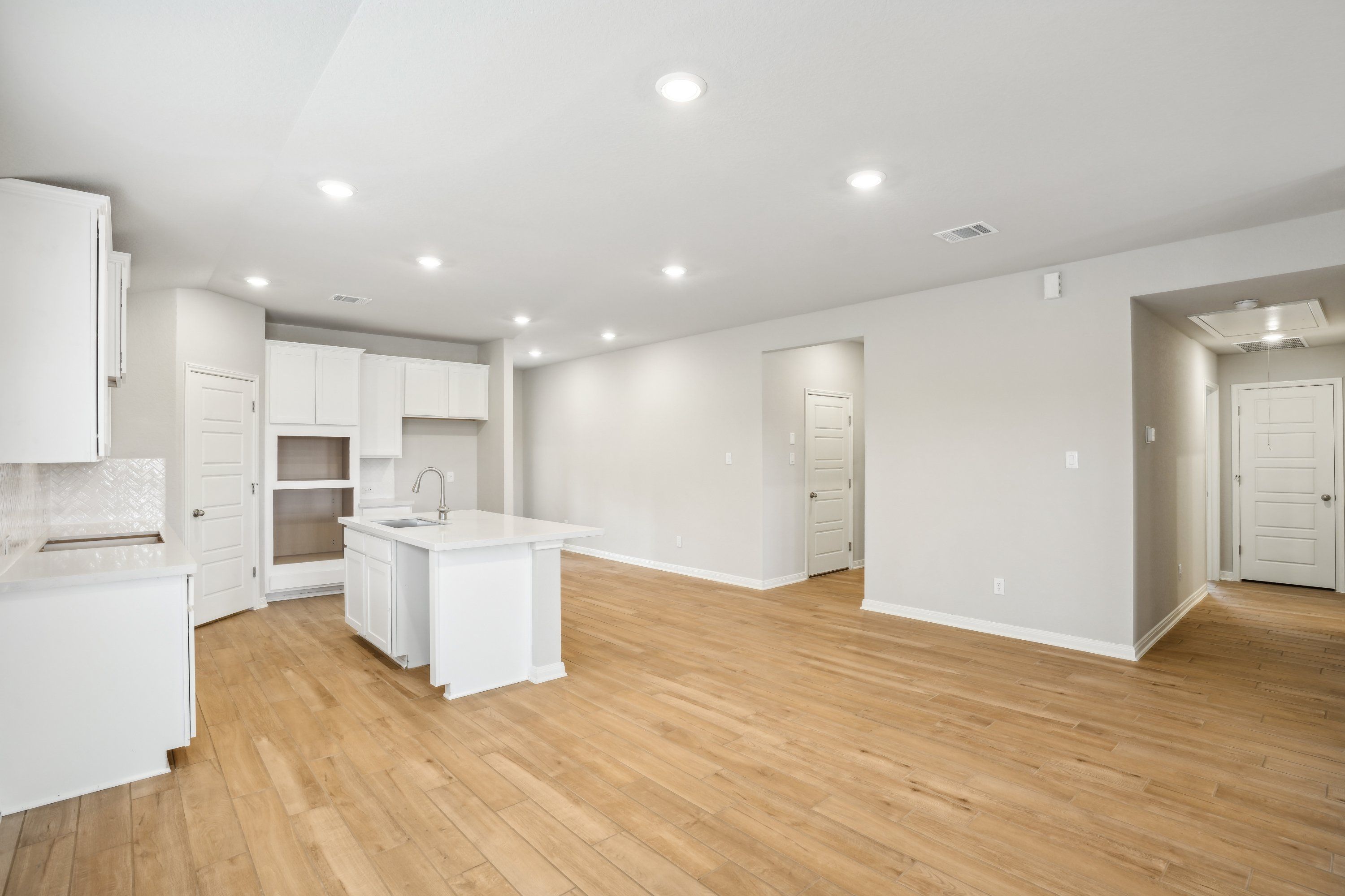 Dining room and kitchen in the Oleander floorplan at a Meritage Homes community.