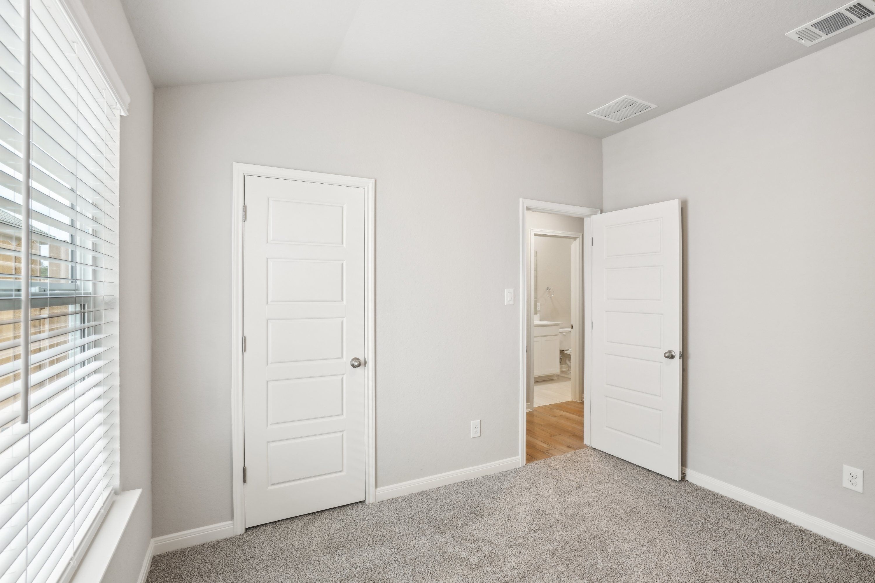 Guest bedroom in the Oleander floorplan at a Meritage Homes community.