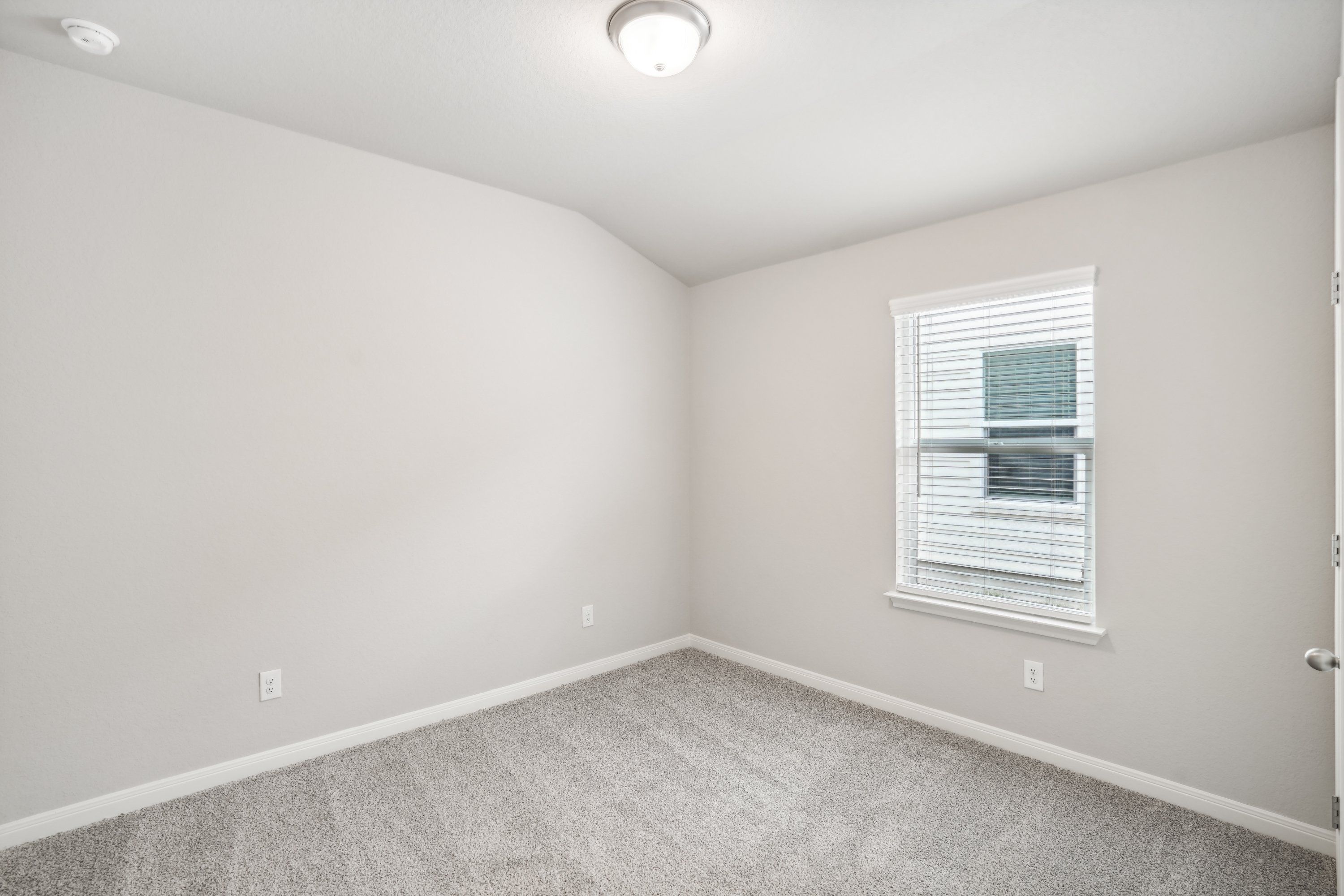 Guest bedroom in the Oleander floorplan at a Meritage Homes community.