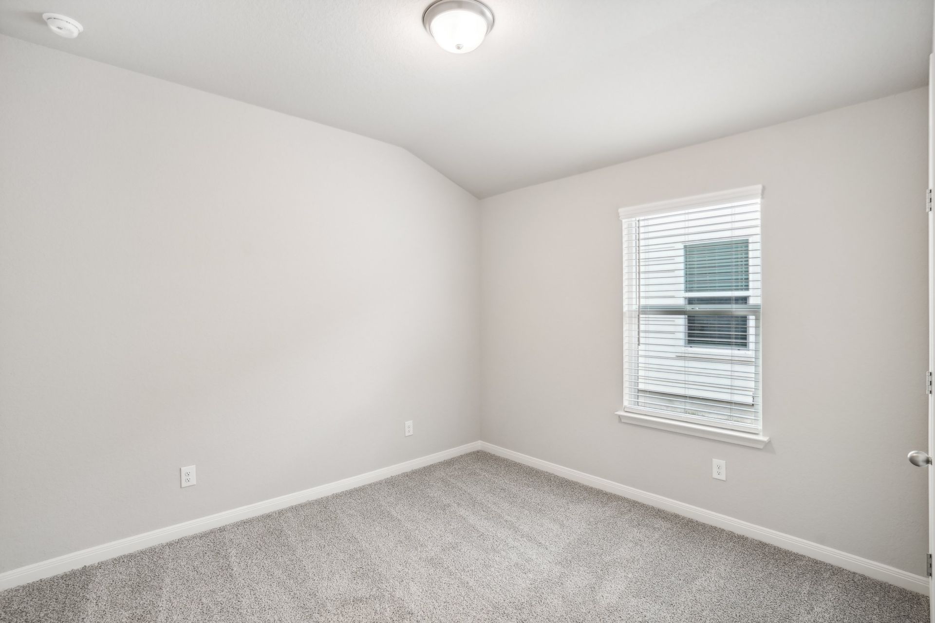 Guest bedroom in the Oleander floorplan at a Meritage Homes community.