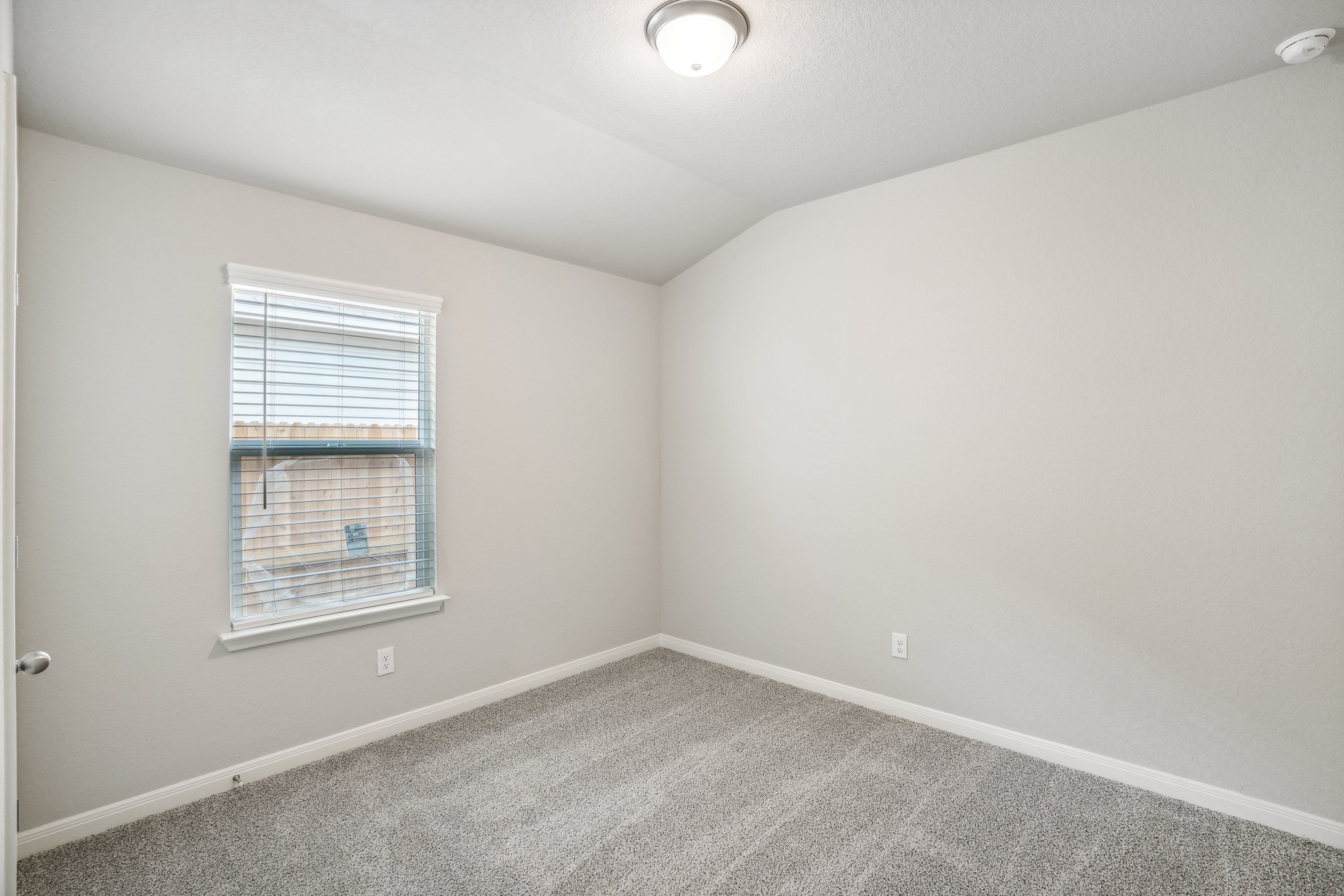 Guest bedroom in the Oleander floorplan at a Meritage Homes community.